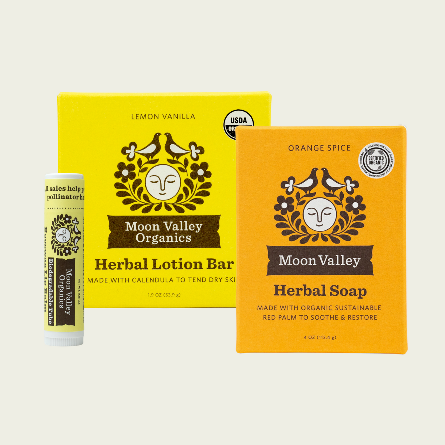 Moon Valley Organics Skin Essential Set with Orange Spice Herbal Soap with Lotion Bar and Lip Balm Front Boxes