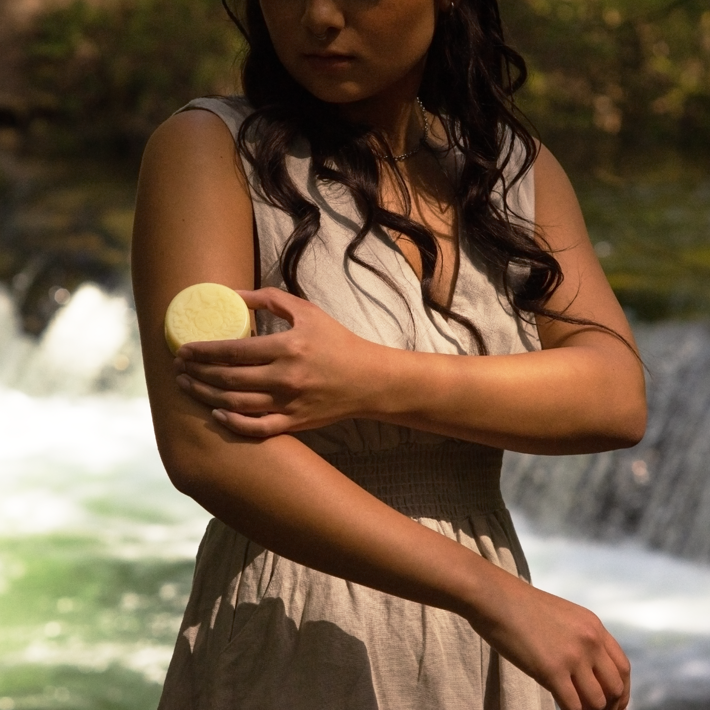 Moon Valley Organics Herbal Lotion Bar Woman rubs lotion bar on her arm