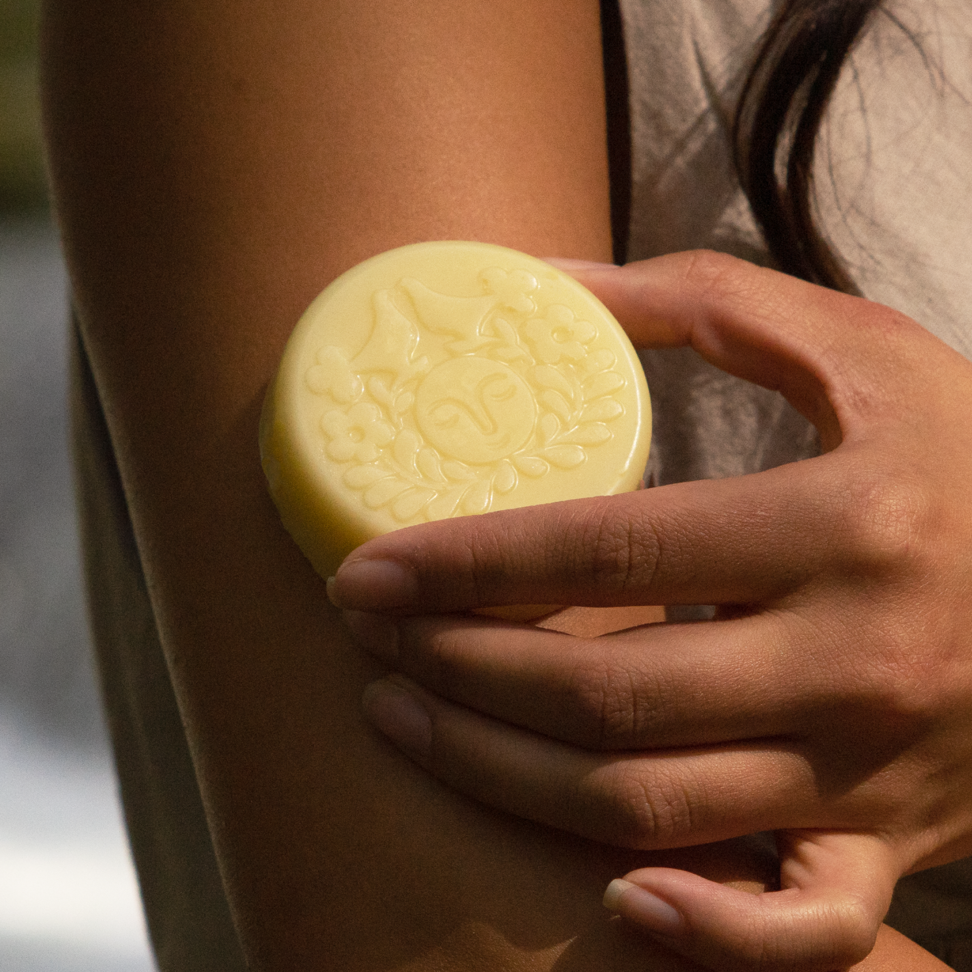 Moon Valley Organics Herbal Lotion Bar Hand rubs lotion bar on arm