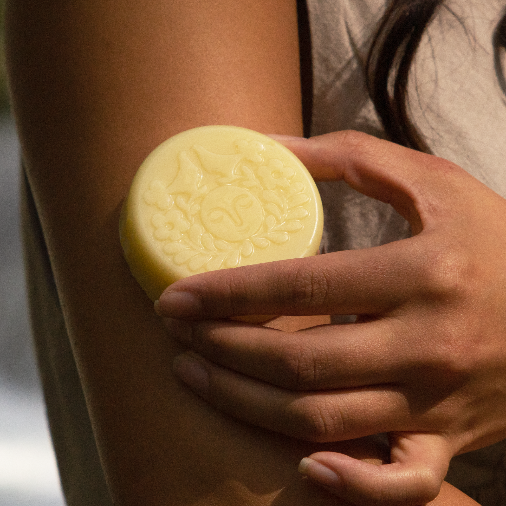 Moon Valley Organics Herbal Lotion Bar Hand rubs lotion bar on arm